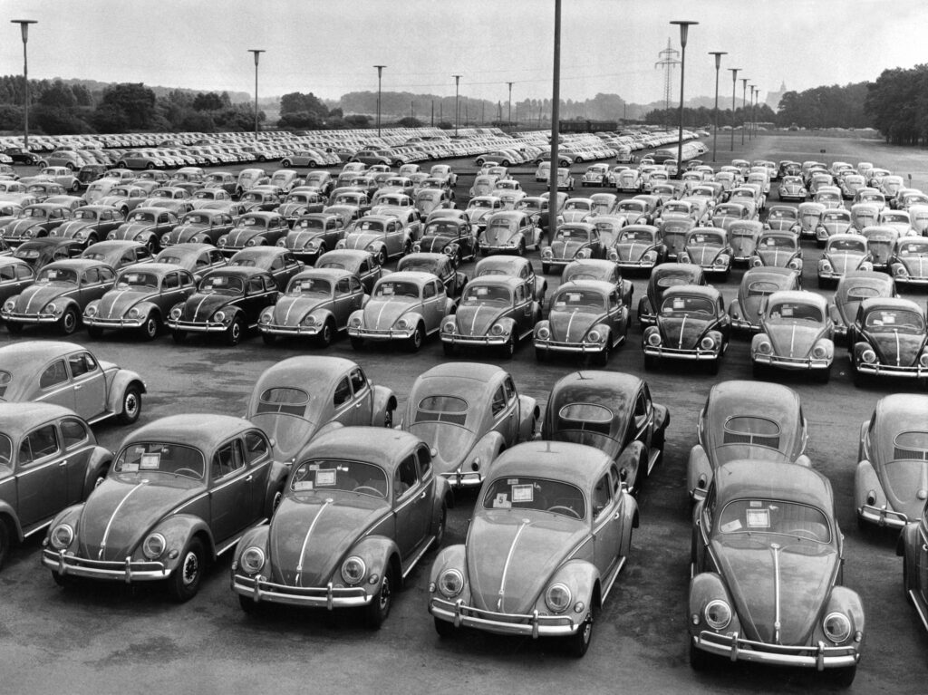 Black and white image of rows of new VW Beetles